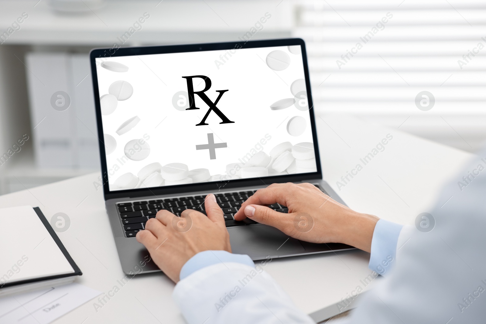 Image of Medical prescription. Doctor working on laptop at table in clinic, closeup