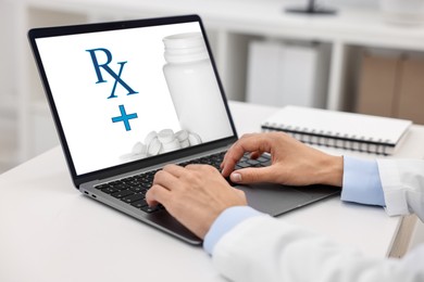 Image of Medical prescription. Doctor working on laptop at table in clinic, closeup