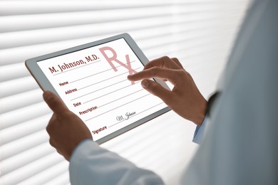 Image of Doctor filling in medical prescription on tablet in clinic, closeup