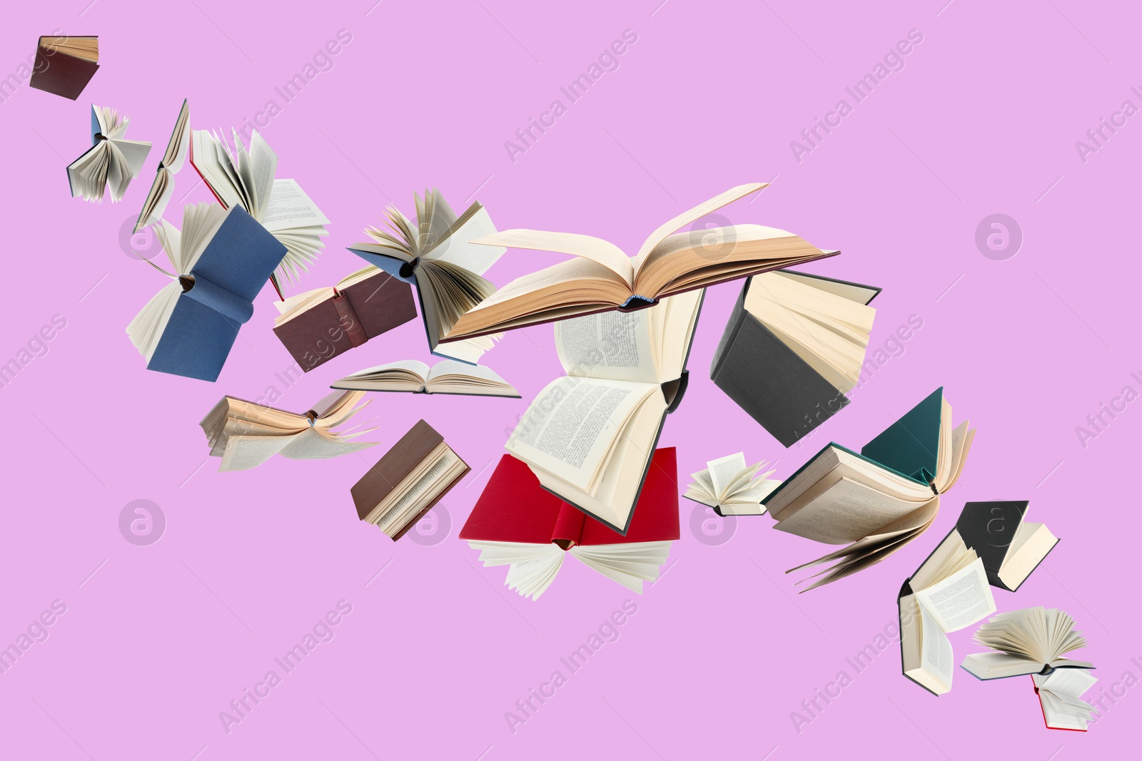 Image of Many different books in air on light violet background