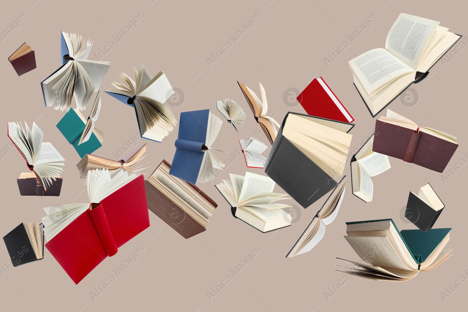 Image of Many different books in air on dark beige background