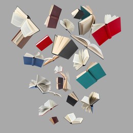 Image of Many different books in air on light grey background