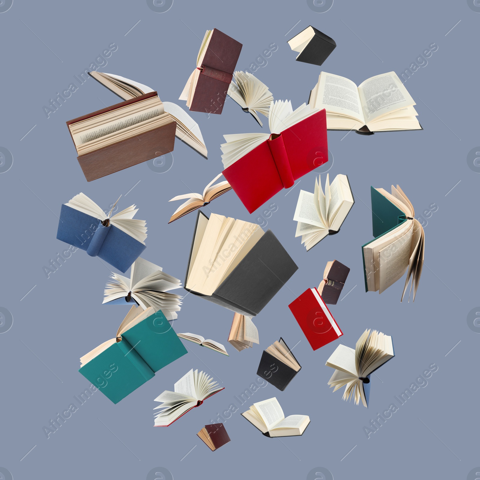 Image of Many different books in air on grey background