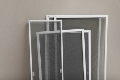 Photo of Set of window screens near beige wall