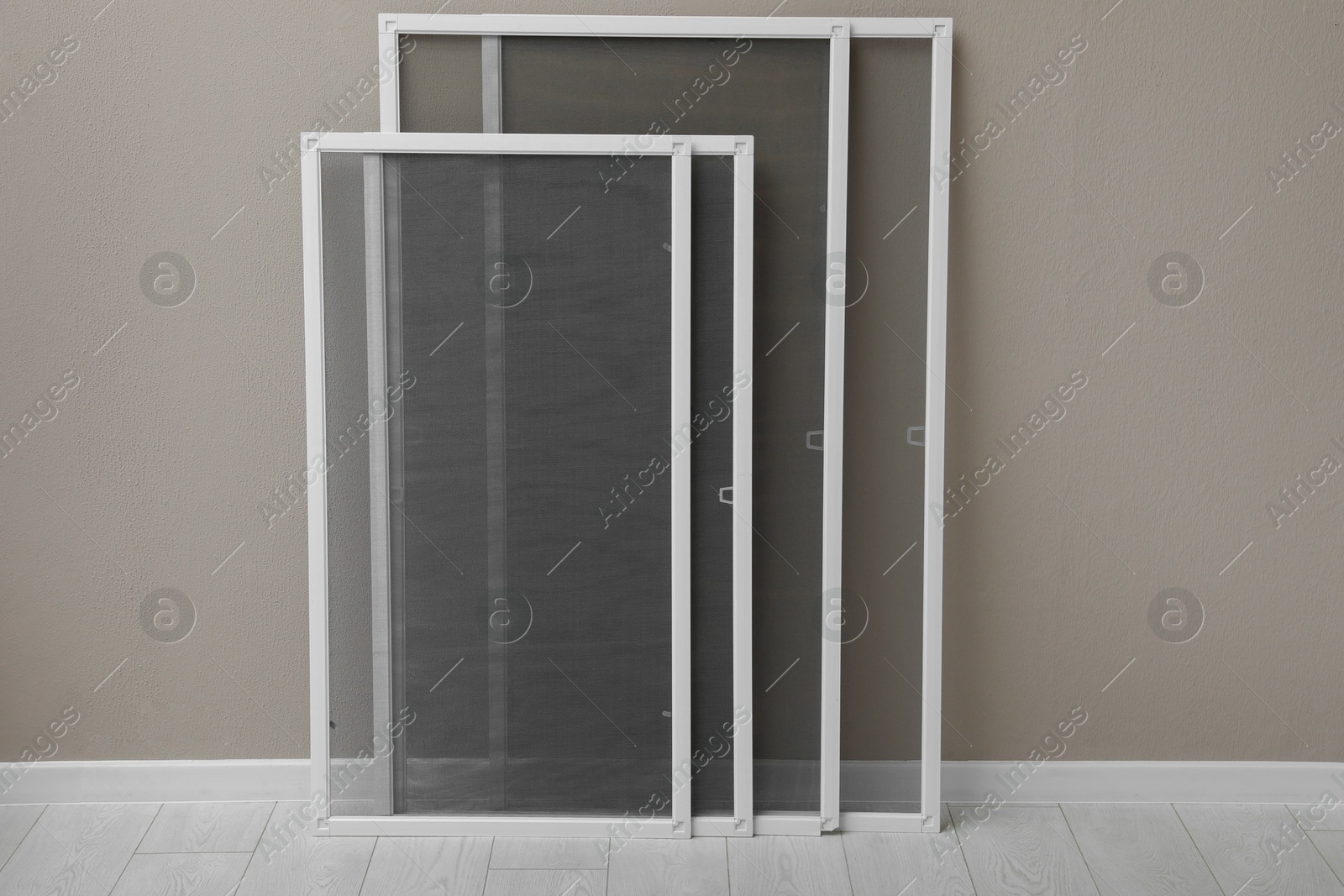 Photo of Set of window screens near beige wall indoors