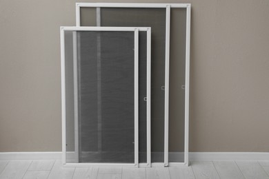 Photo of Set of window screens near beige wall indoors