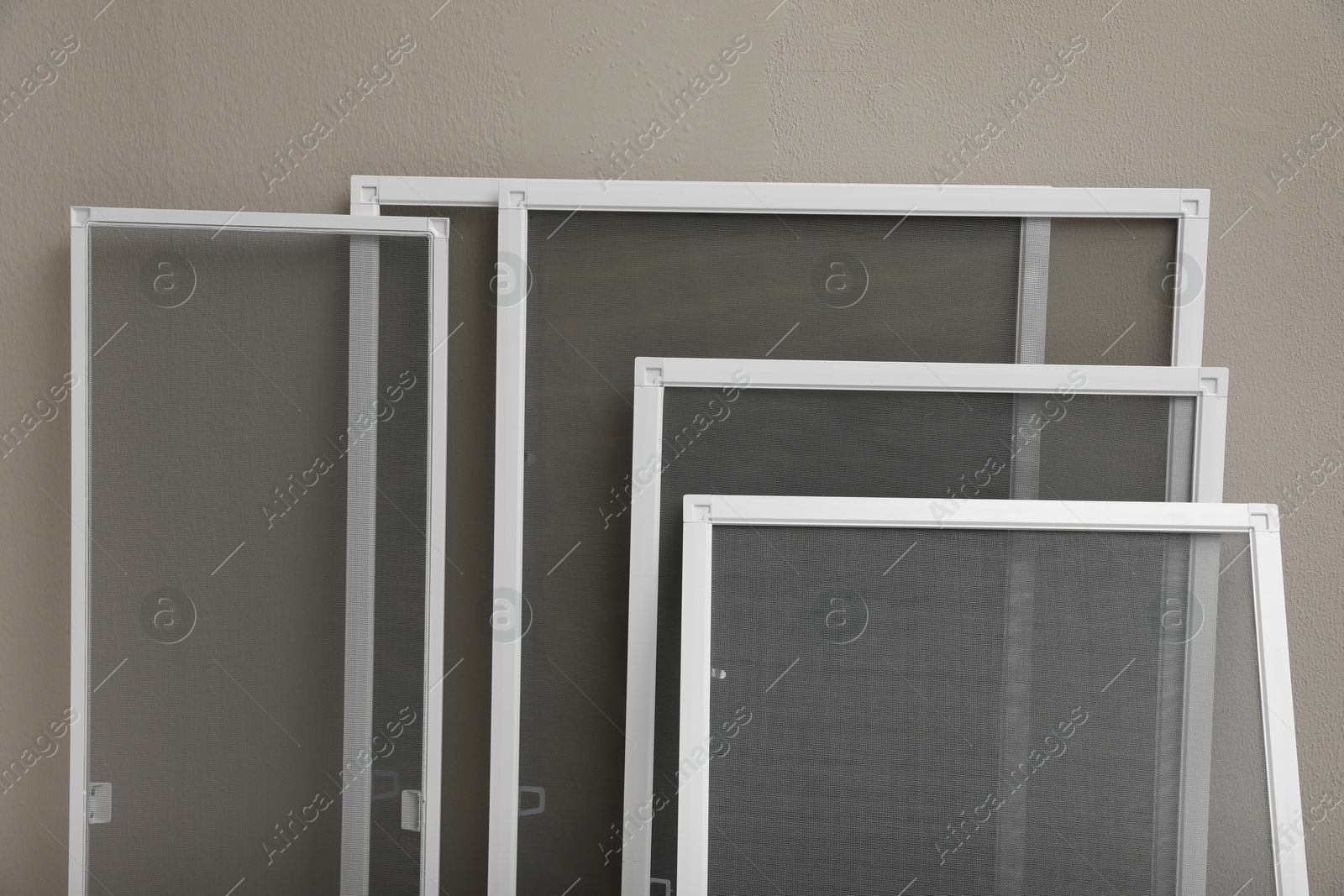 Photo of Set of window screens near beige wall