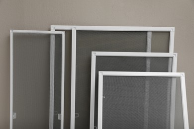 Photo of Set of window screens near beige wall