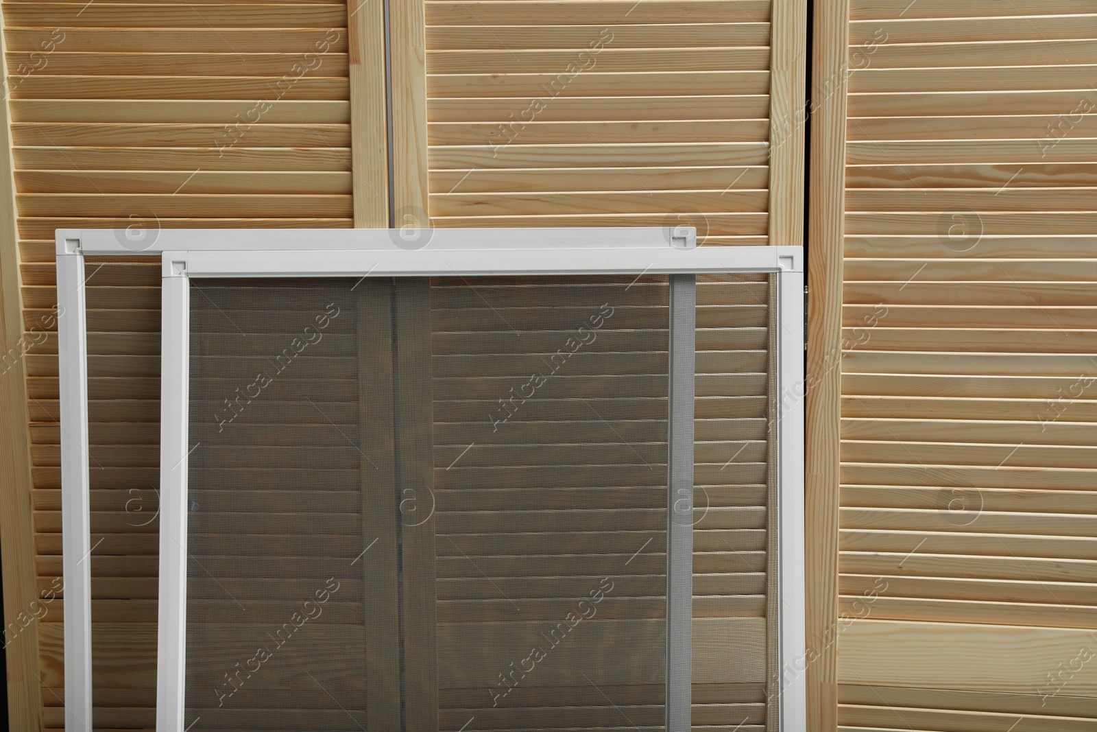 Photo of New window screens near wooden folding screen