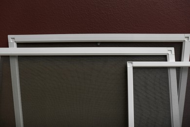 Set of window screens near brown wall