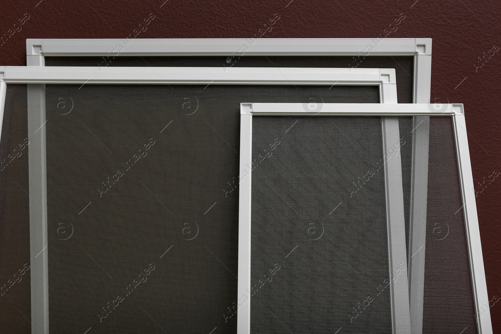 Photo of Set of window screens near brown wall