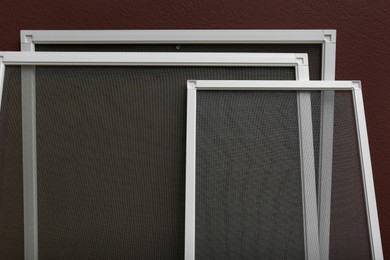 Set of window screens near brown wall