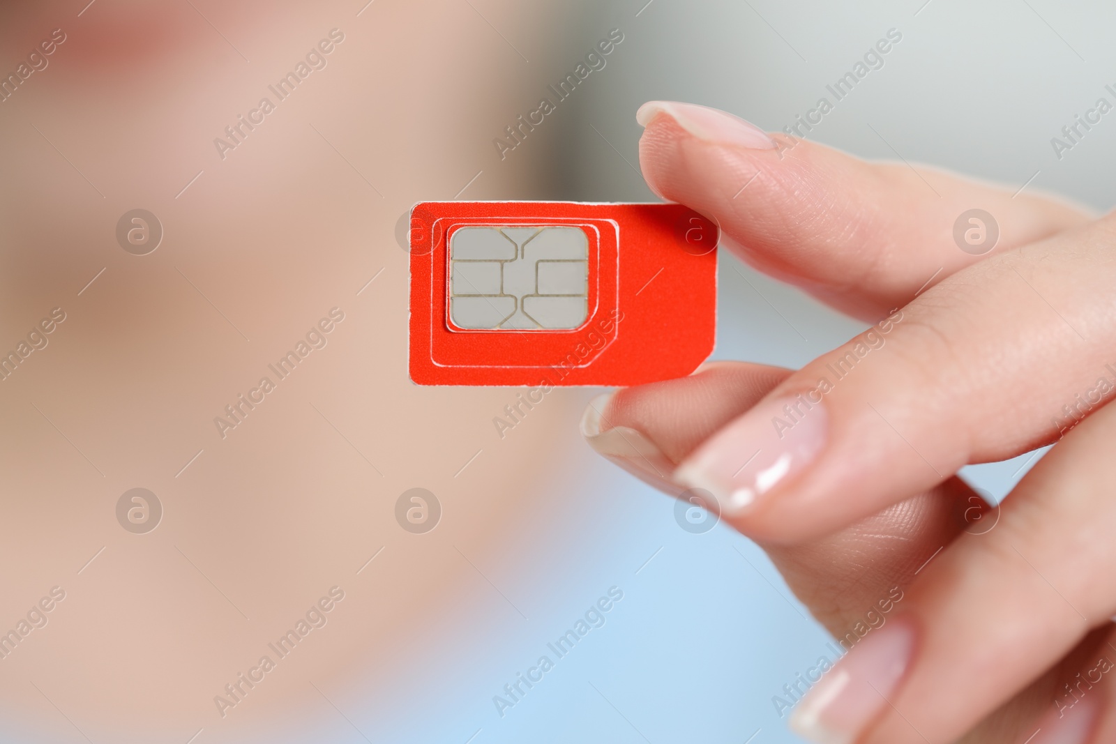 Photo of Woman holding SIM card, closeup. Space for text