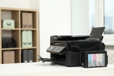 Photo of Modern printer on white table in office