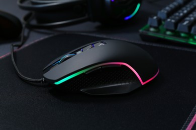 Photo of Wired computer mouse and mousepad on table