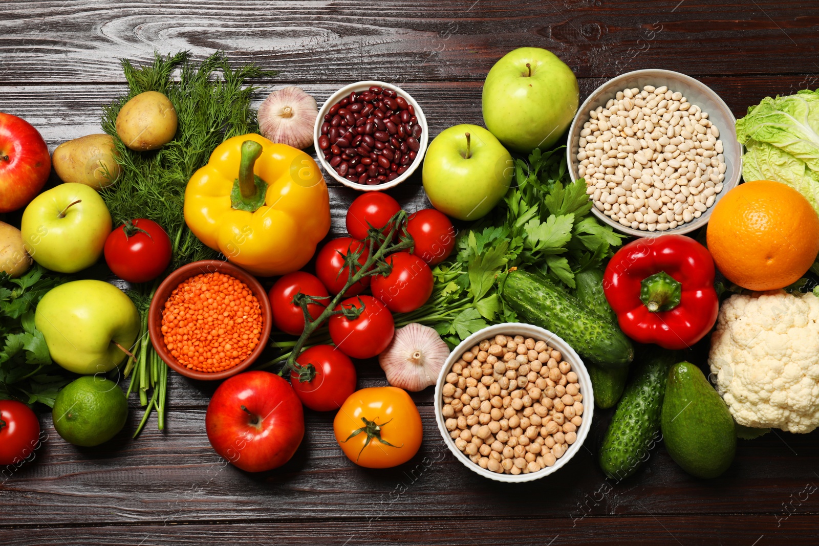 Photo of Different vegetarian products on wooden table, top view