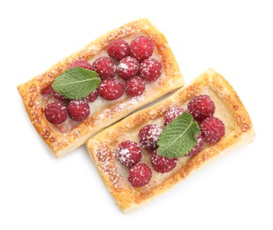 Photo of Tasty puff pastries with raspberries and mint isolated on white, top view