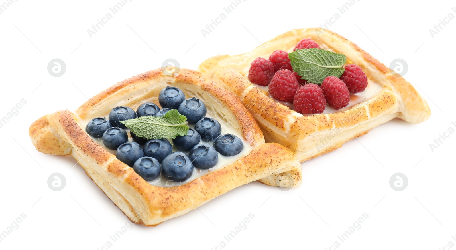 Photo of Tasty puff pastries with berries isolated on white