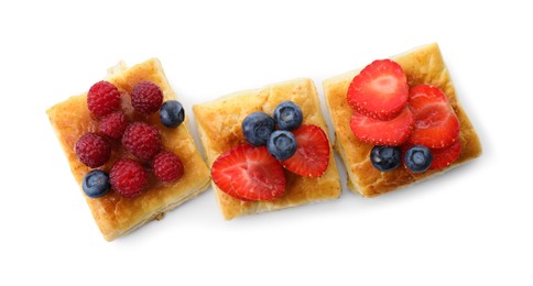 Tasty puff pastries with berries isolated on white, top view