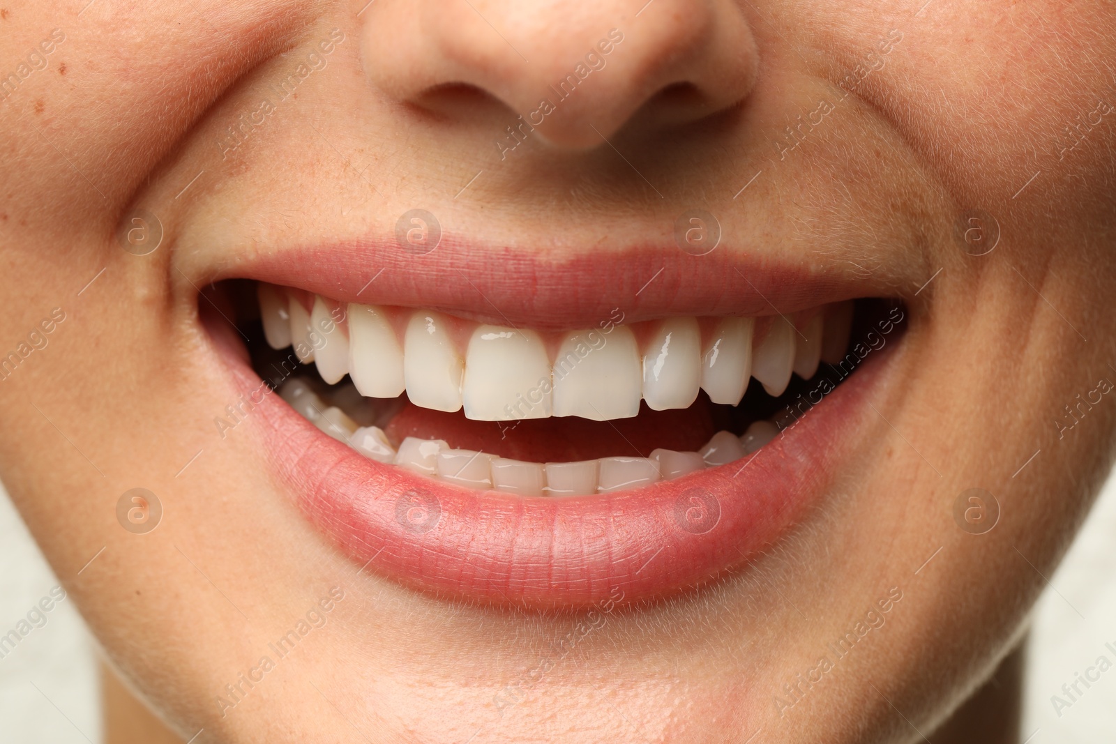 Photo of Smiling woman with healthy clean teeth, closeup