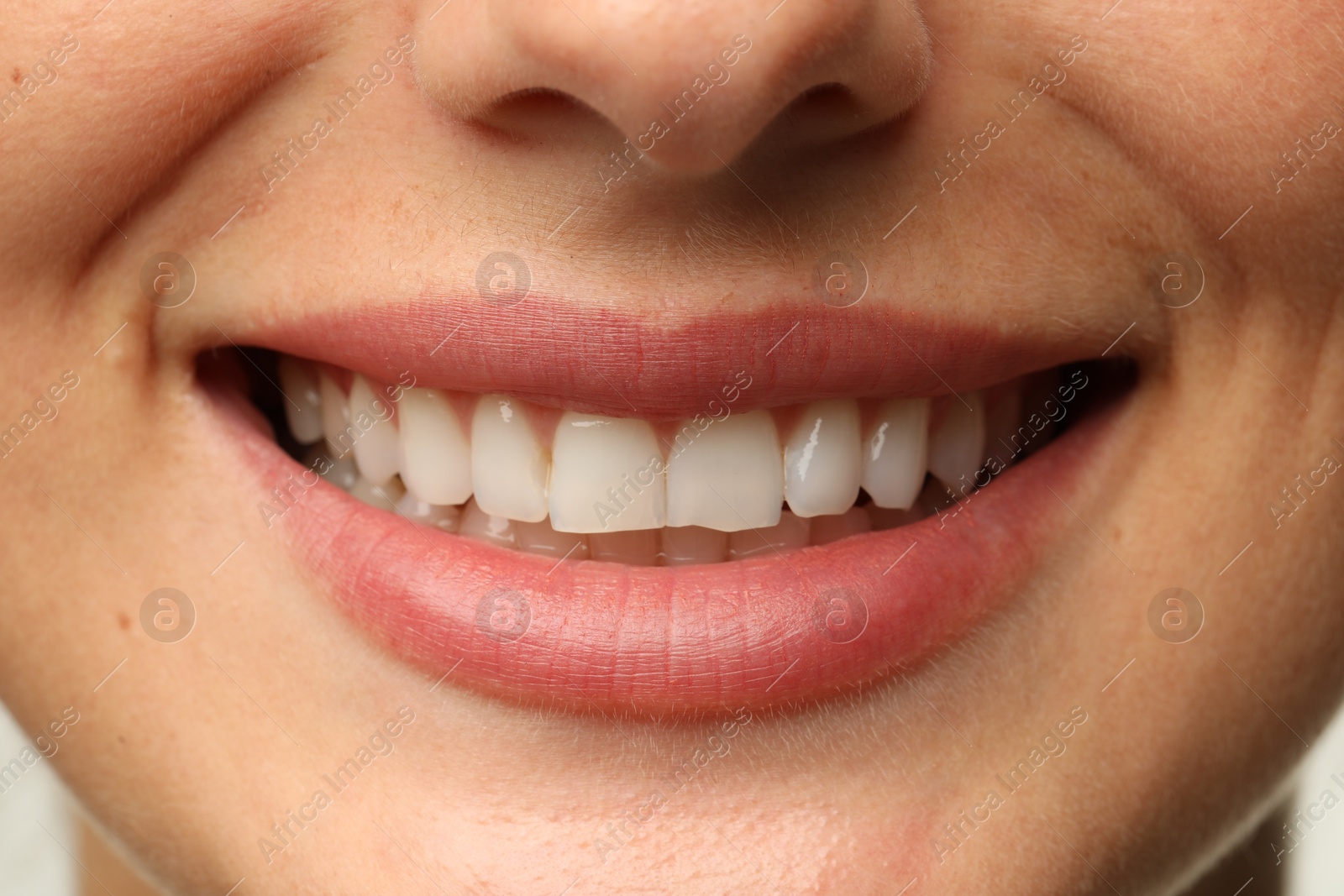 Photo of Smiling woman with healthy clean teeth, closeup