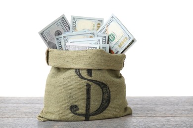 Photo of Dollar banknotes in bag on wooden table against white background