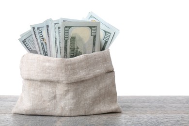 Photo of Dollar banknotes in bag on wooden table against white background, space for text