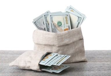 Photo of Dollar banknotes in bags on wooden table against white background