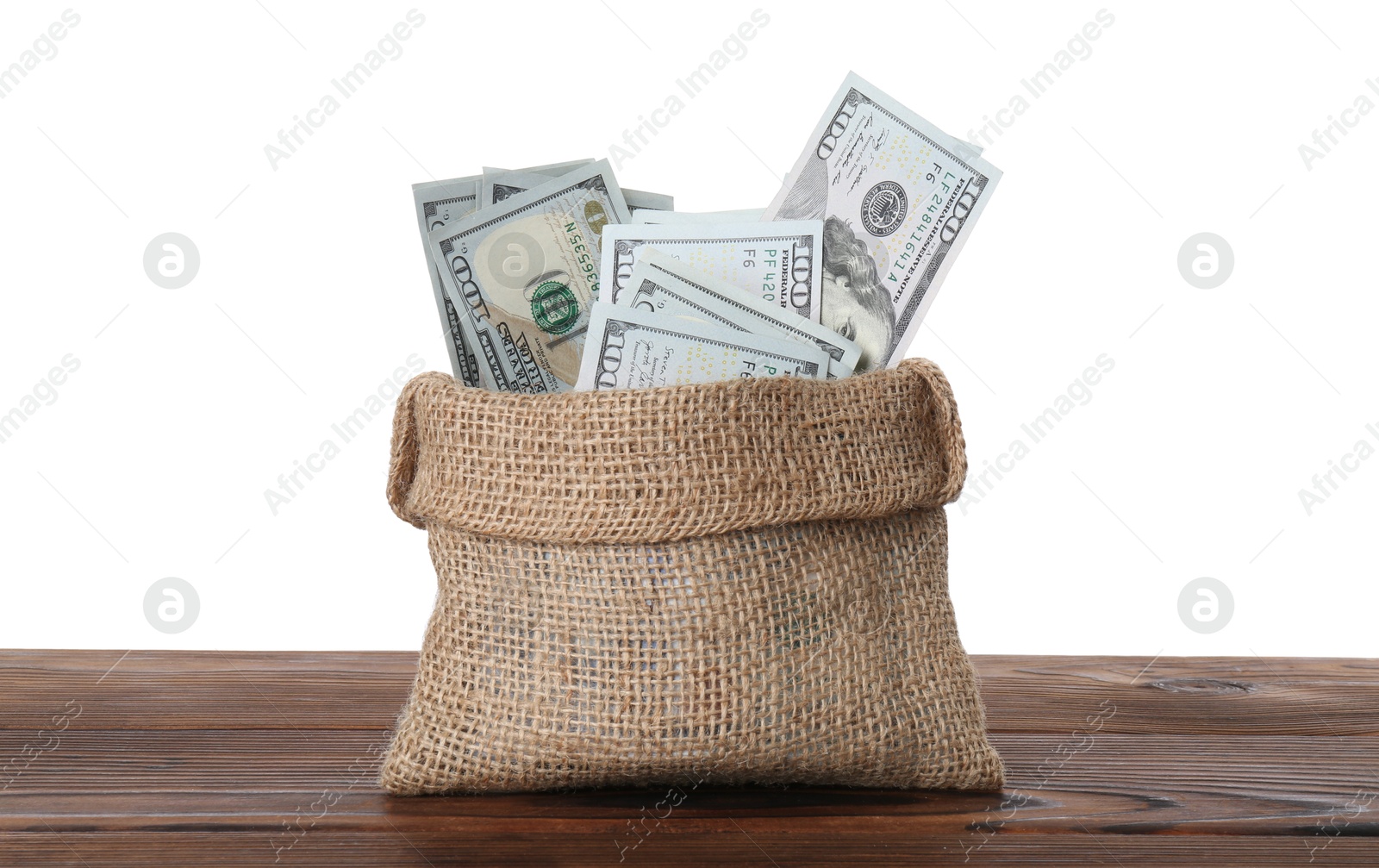 Photo of Dollar banknotes in bag on wooden table against white background