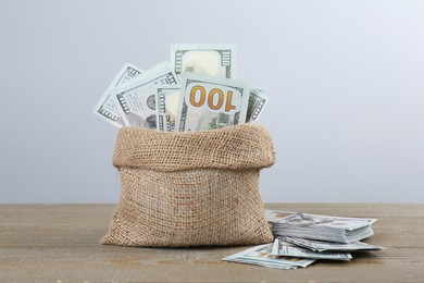 Photo of Dollar banknotes in bag on wooden table