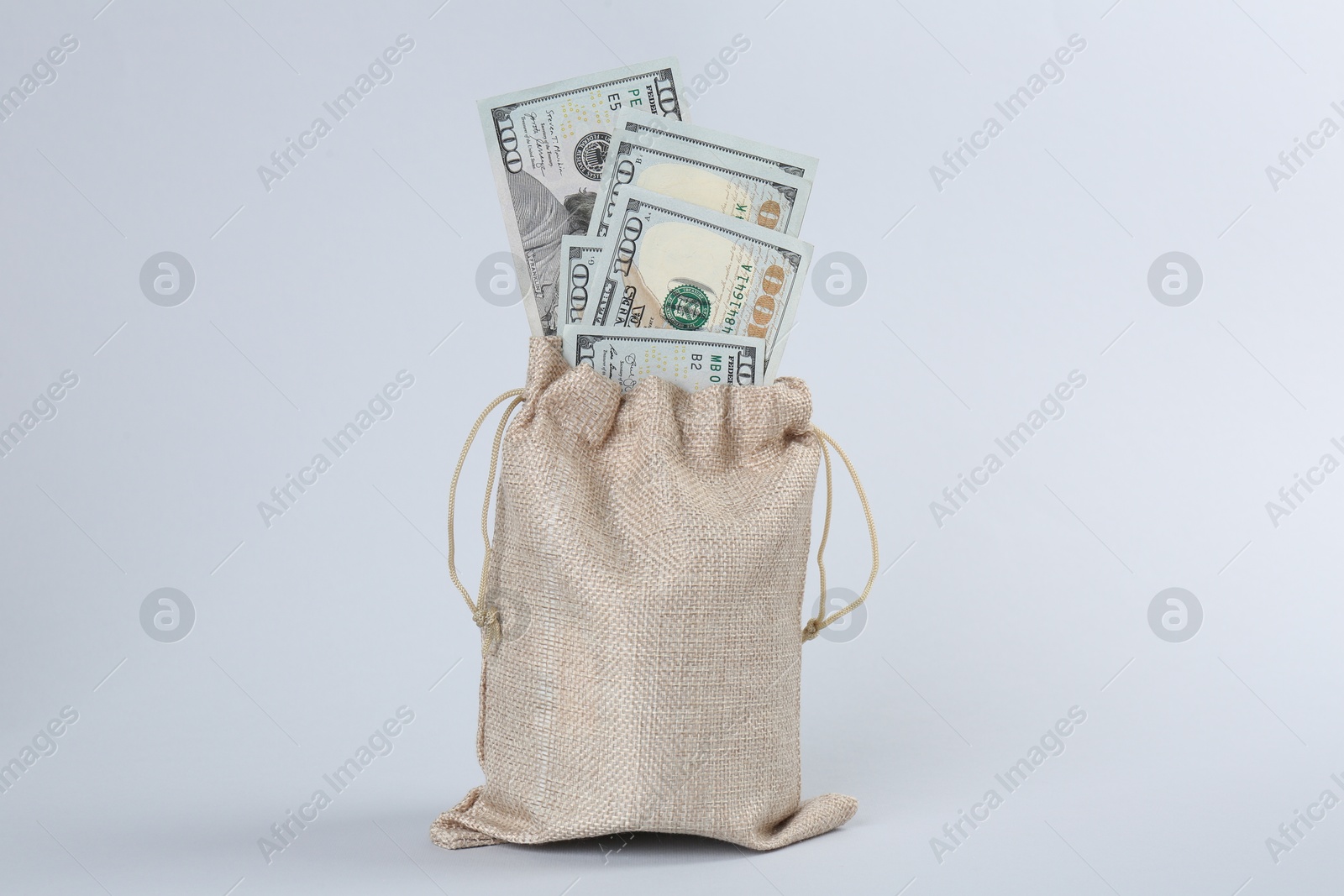 Photo of Dollar banknotes in bag on grey background