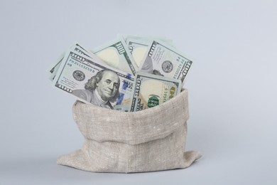 Photo of Dollar banknotes in bag on grey background