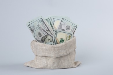 Photo of Dollar banknotes in bag on grey background