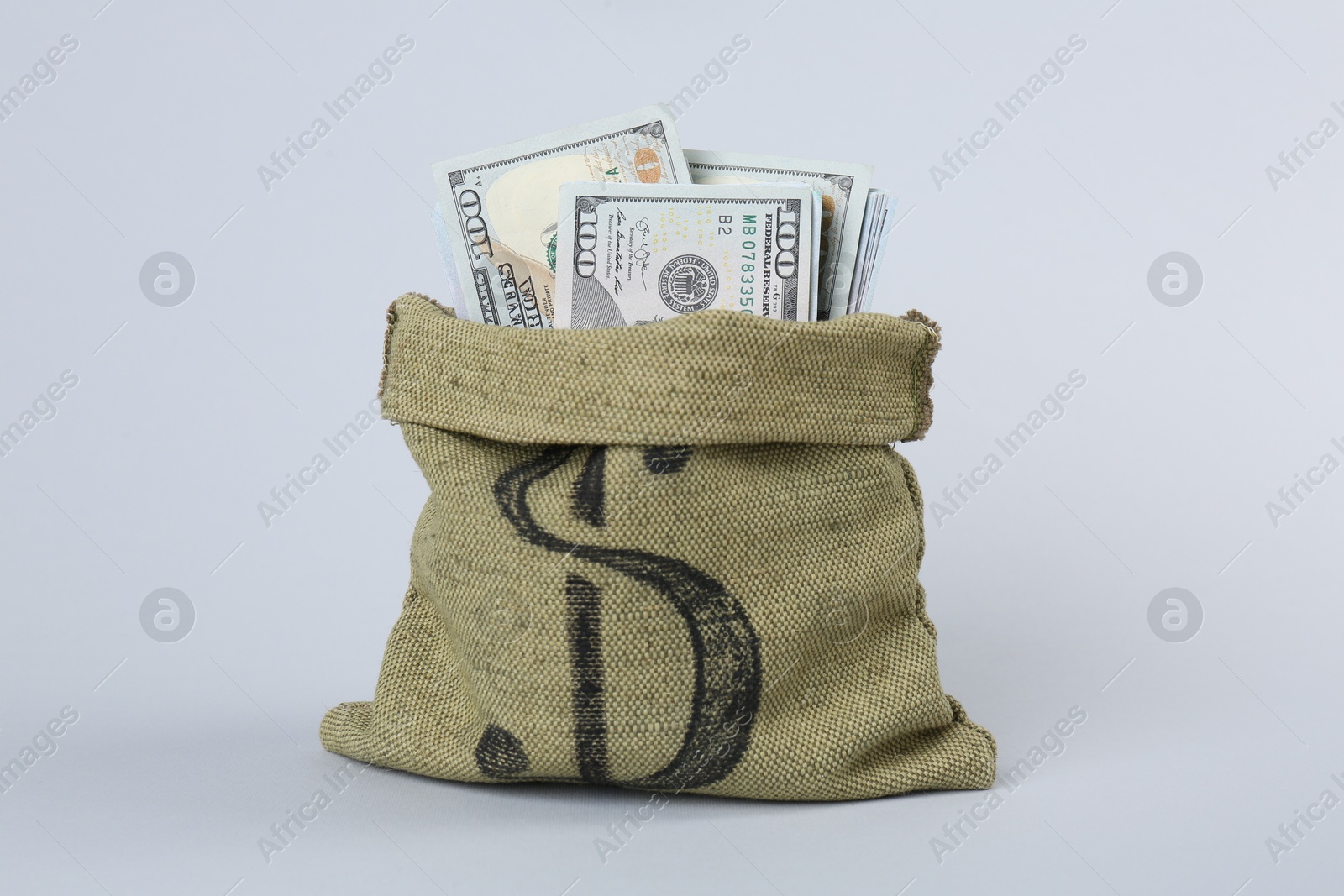 Photo of Dollar banknotes in bag on grey background