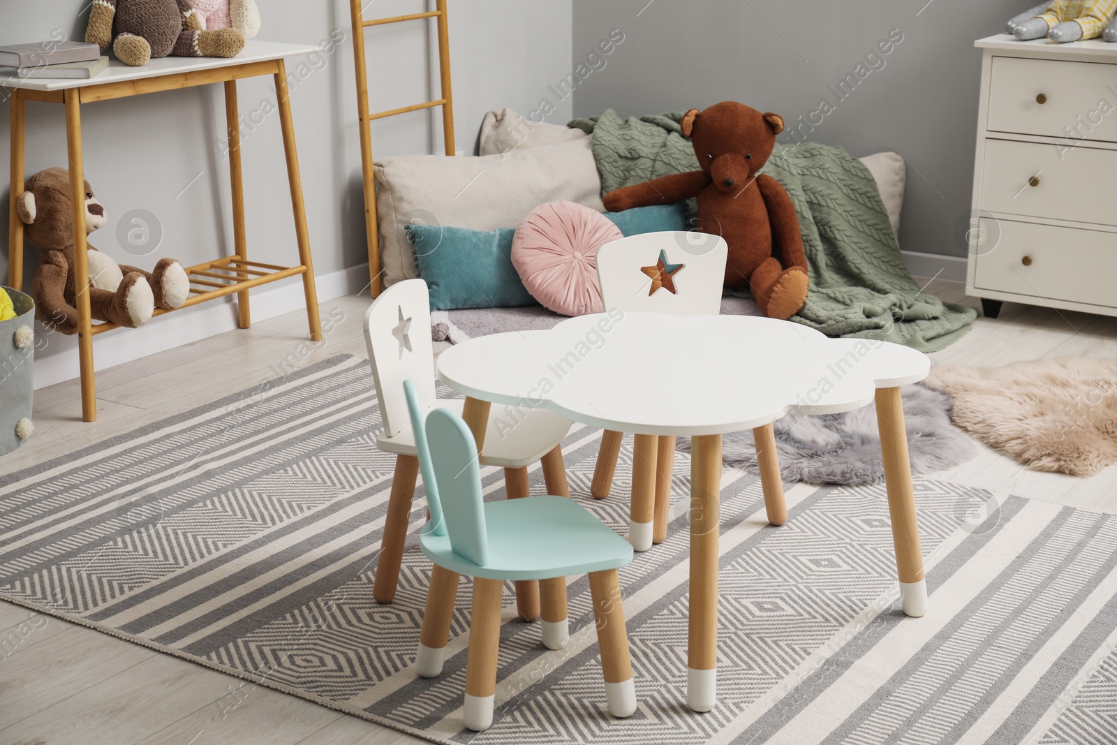 Photo of Stylish child room interior with modern furniture and toys