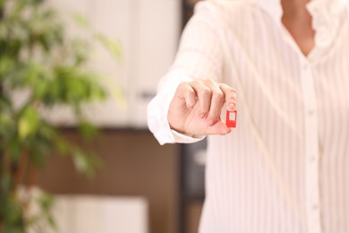 Photo of Woman holding SIM card indoors, closeup. Space for text