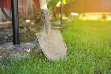 Photo of One rusty shovel in garden. Space for text