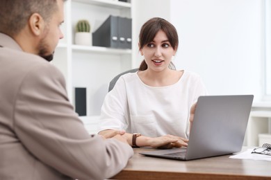 Consultant working with client at table in office. Business meeting