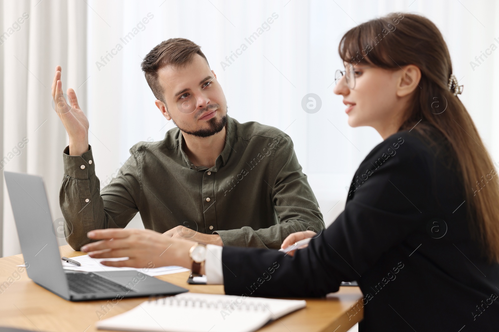 Photo of Consultant working with partner at table in office. Business meeting