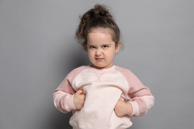 Adorable child. Portrait of cute girl on grey background