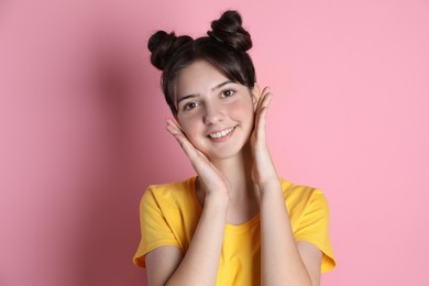 Photo of Portrait of smiling teenage girl on pink background