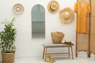 Photo of Mirror on white wall in room. Interior design