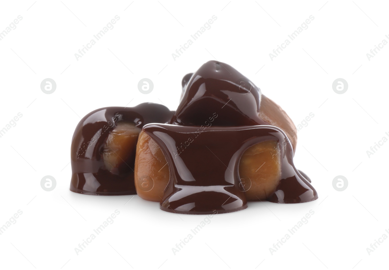 Photo of Delicious caramel candies with melted chocolate isolated on white