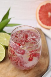 Photo of Refreshing water with red currants in glass on white table, closeup