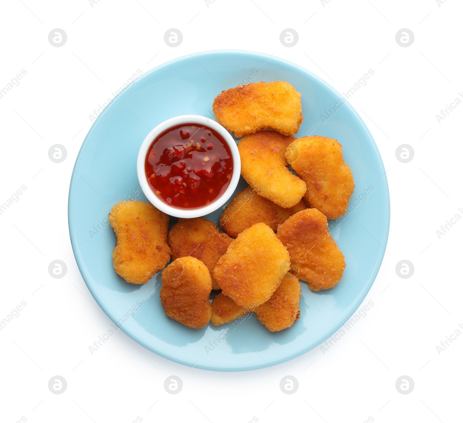 Photo of Tasty chicken nuggets with chili sauce isolated on white, top view