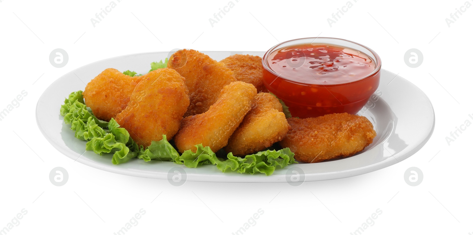 Photo of Tasty chicken nuggets with chili sauce and lettuce isolated on white