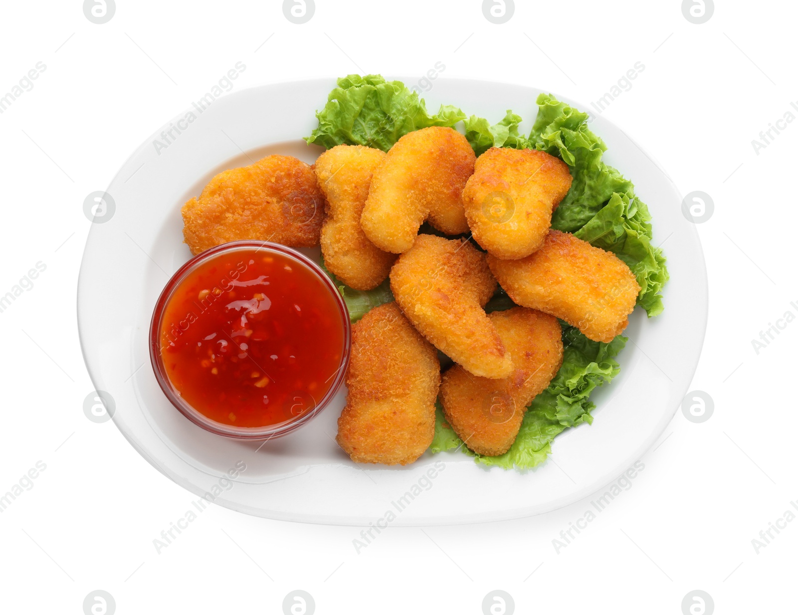 Photo of Tasty chicken nuggets with chili sauce and lettuce isolated on white, top view