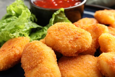 Photo of Tasty crispy chicken nuggets on table, closeup