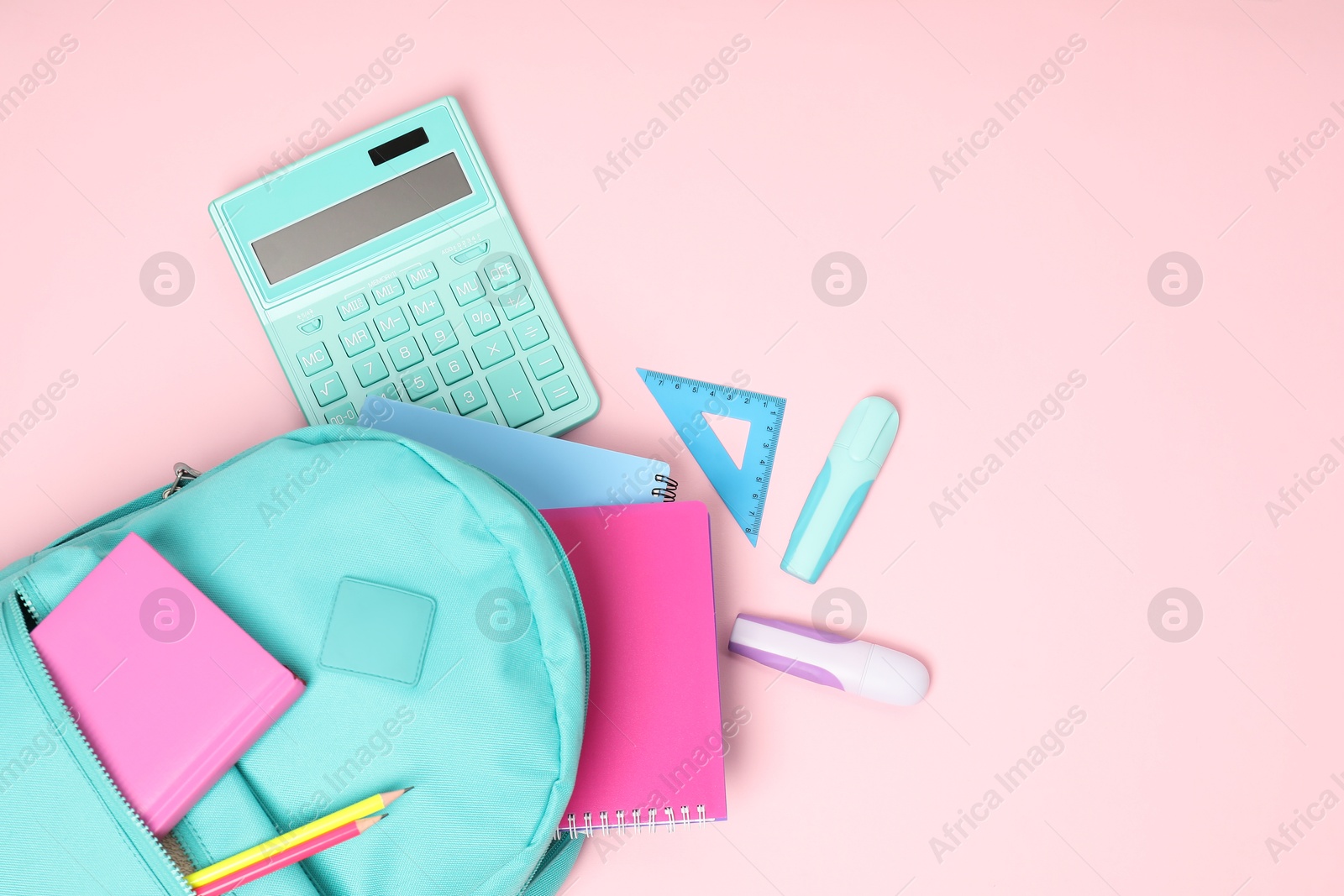 Photo of Backpack with different school stationery on pink background, flat lay. Space for text