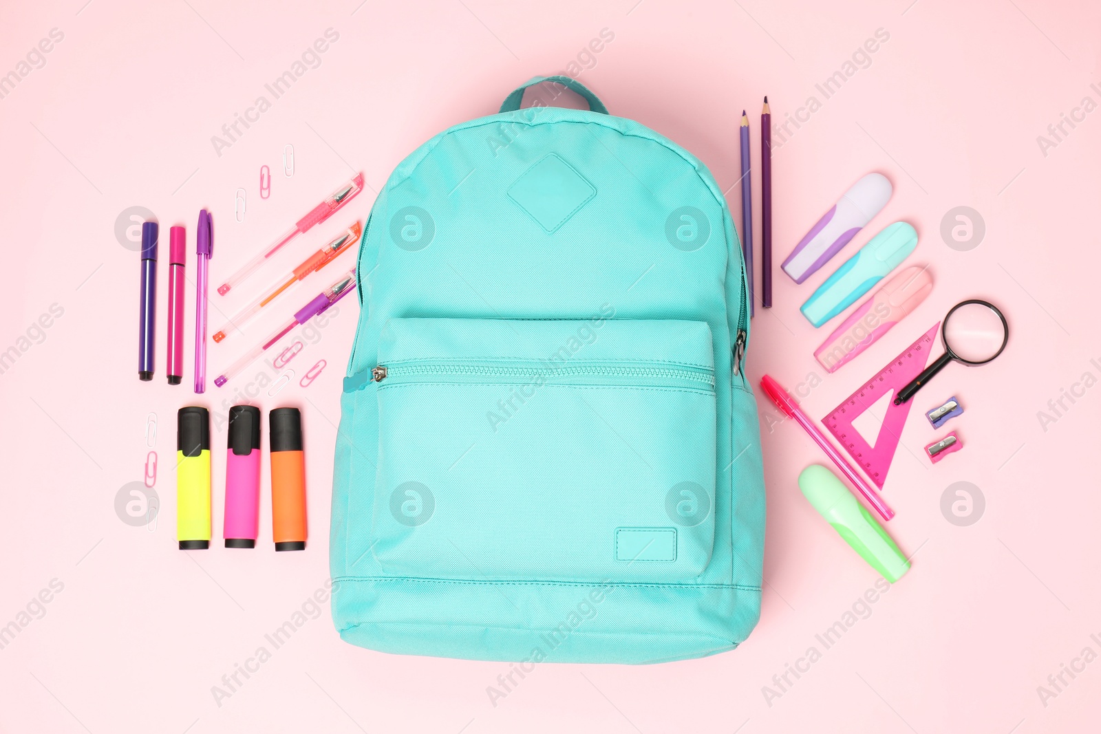 Photo of Flat lay composition with backpack and different stationery on pink background. Back to school